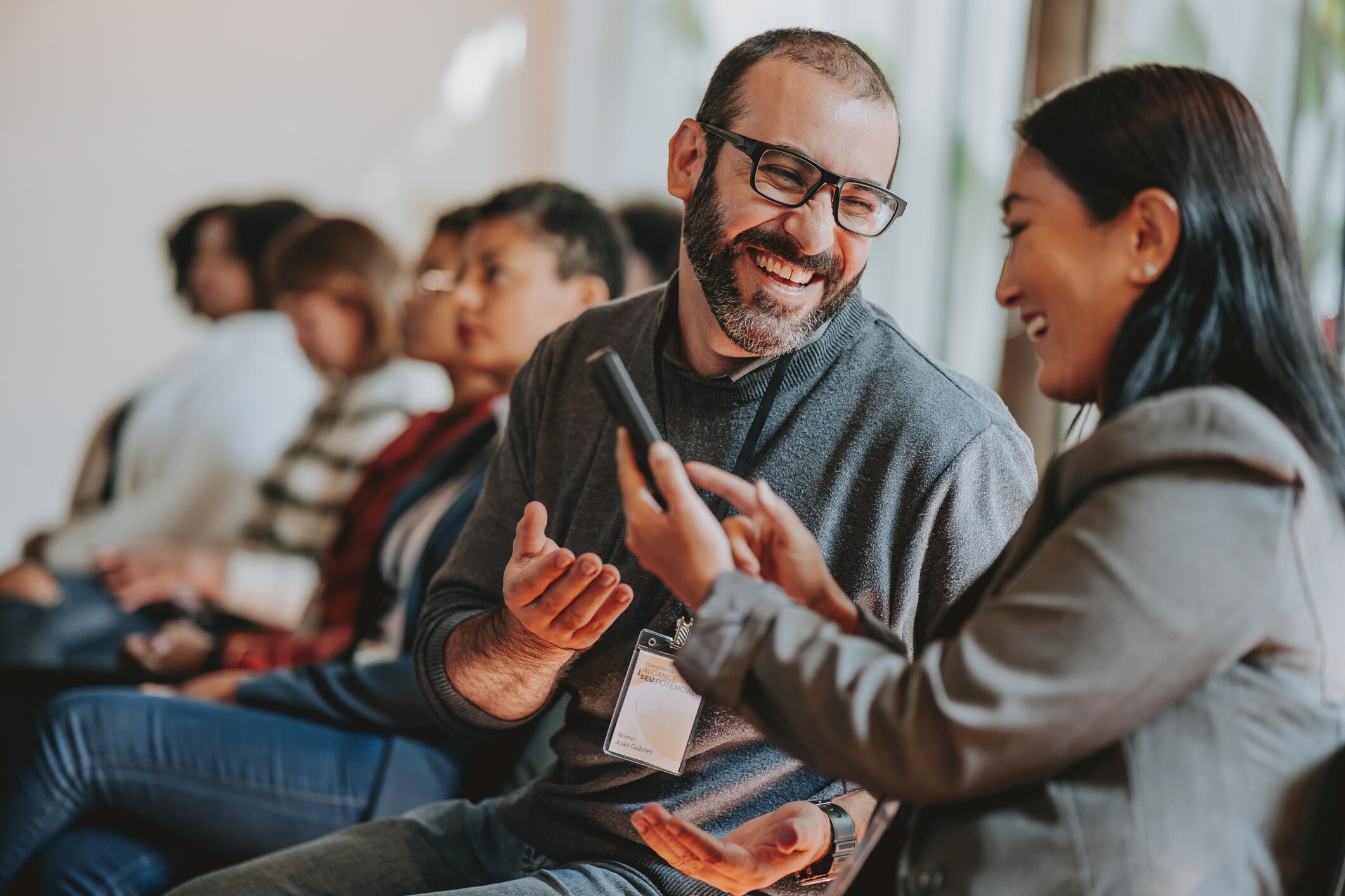 Colleagues talking at a conference. 