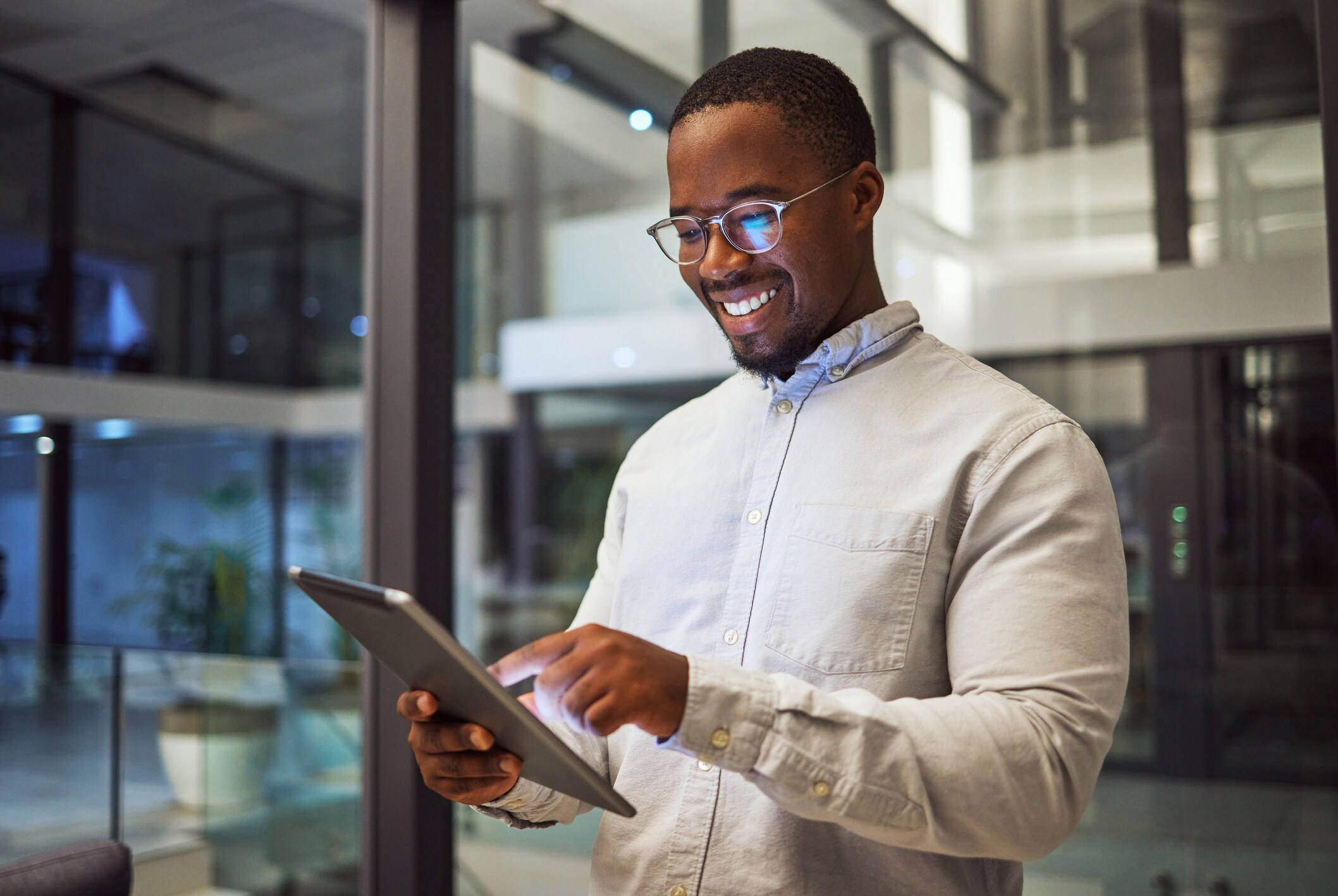 Man smiling looking at a tablet