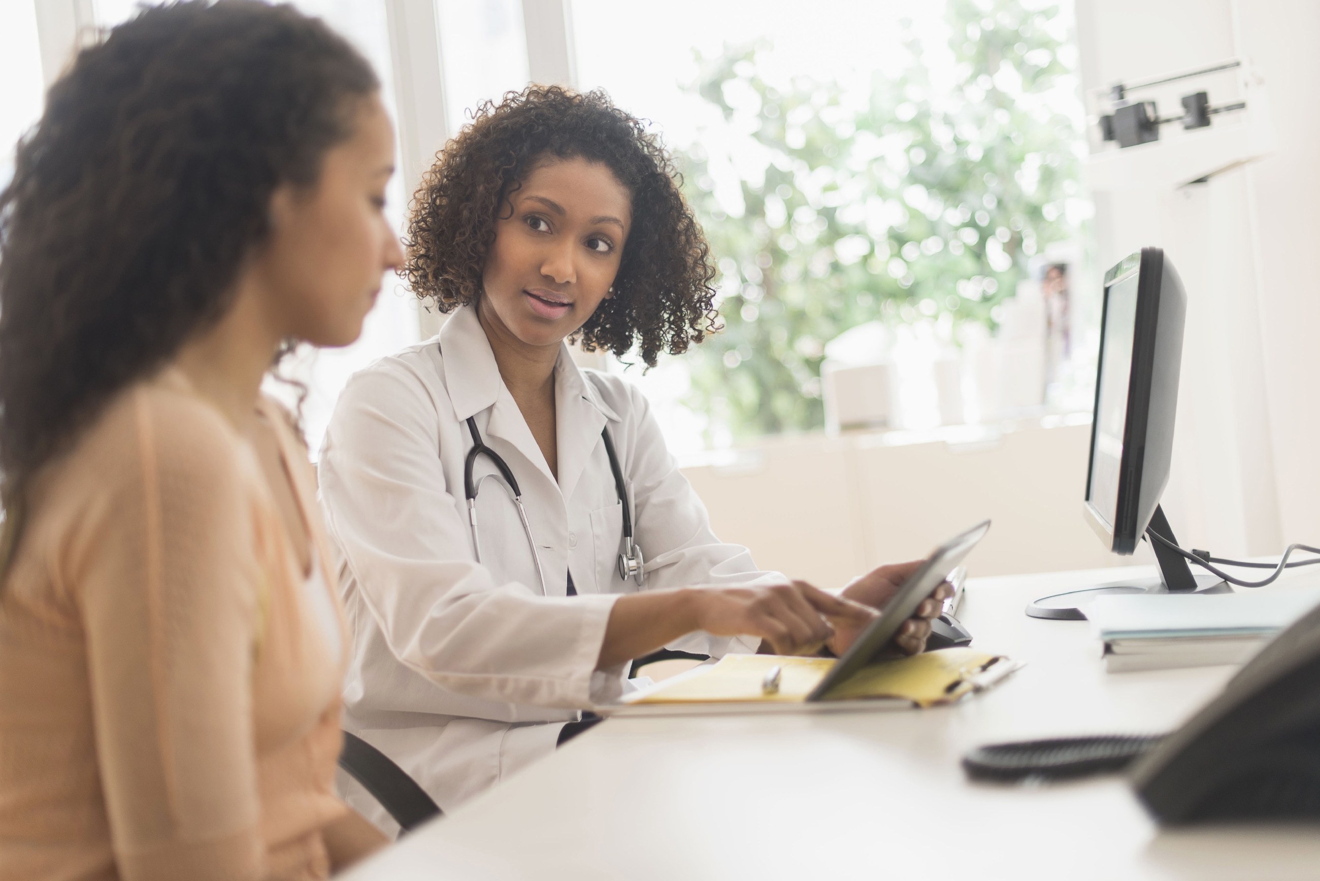 Two women speaking in healthcare setting