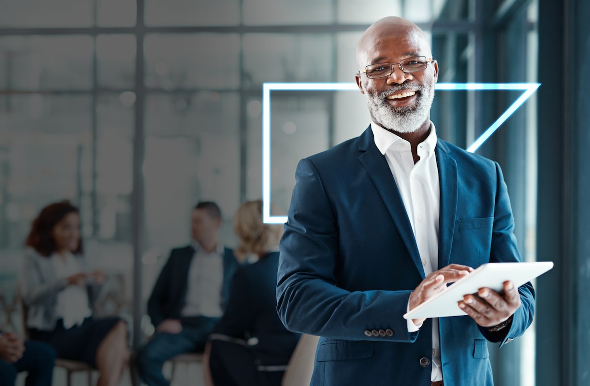 man holding an ipad in a business suit