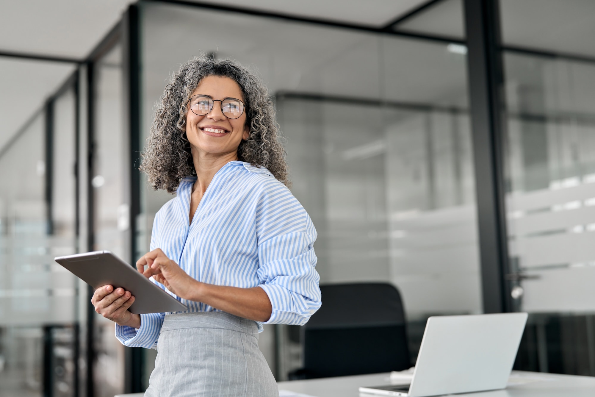 woman smiling holding tablet