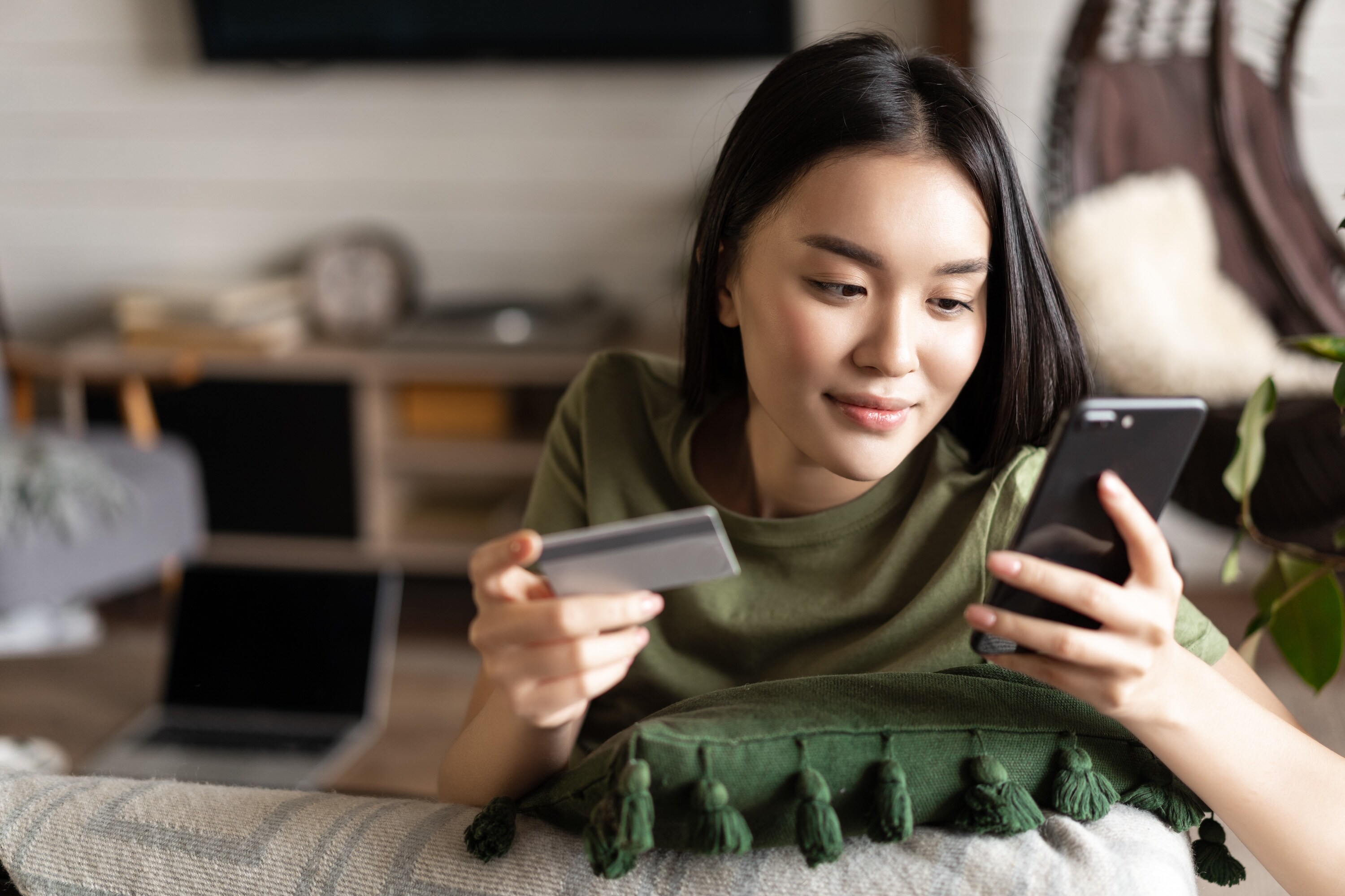 woman paying on her phone with credit card