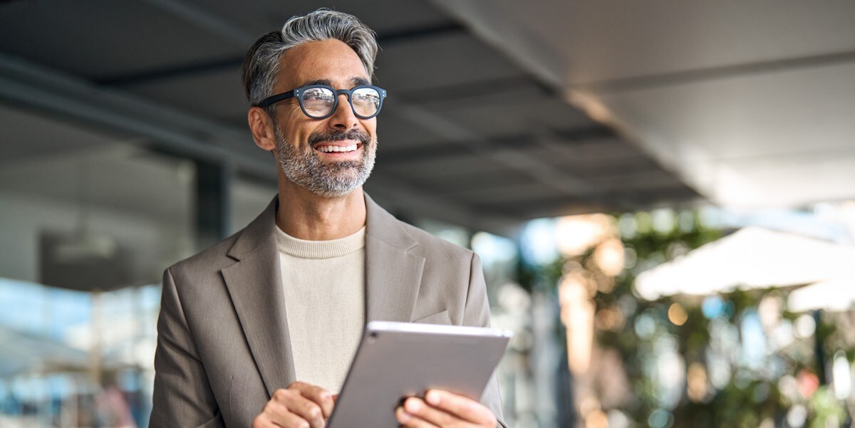 smiling middle aged man with tablet 