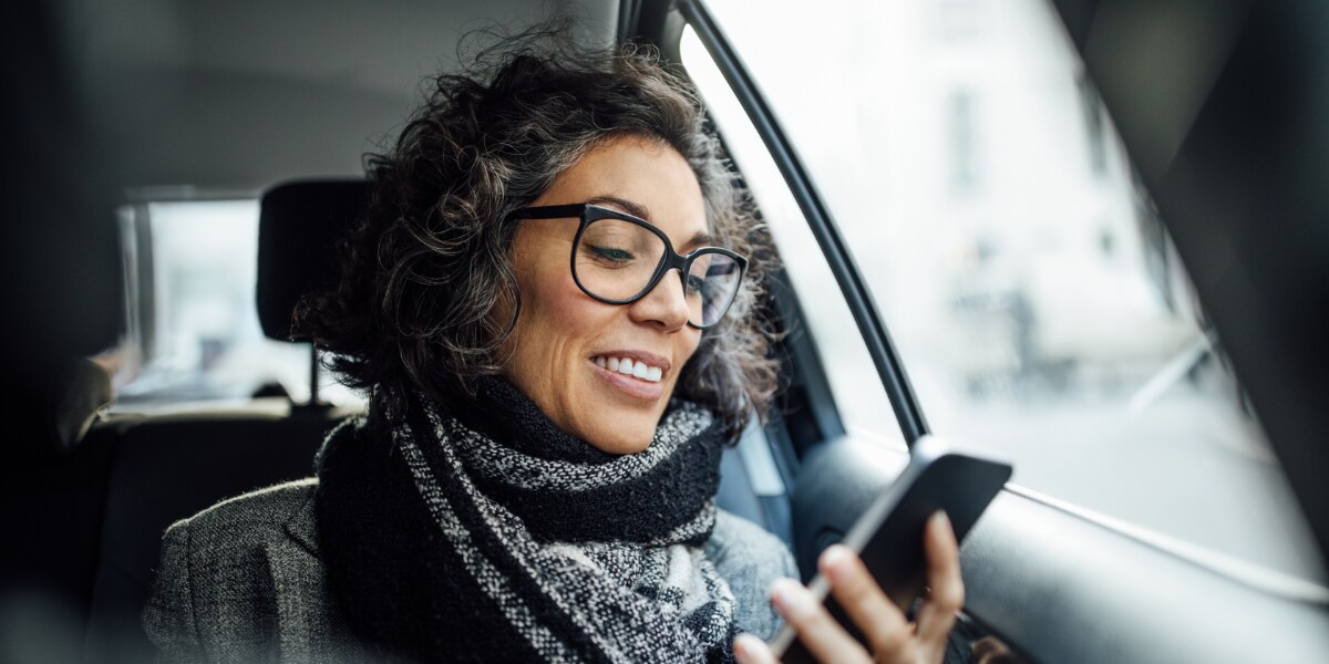 a business traveler booking her trip via mobile
