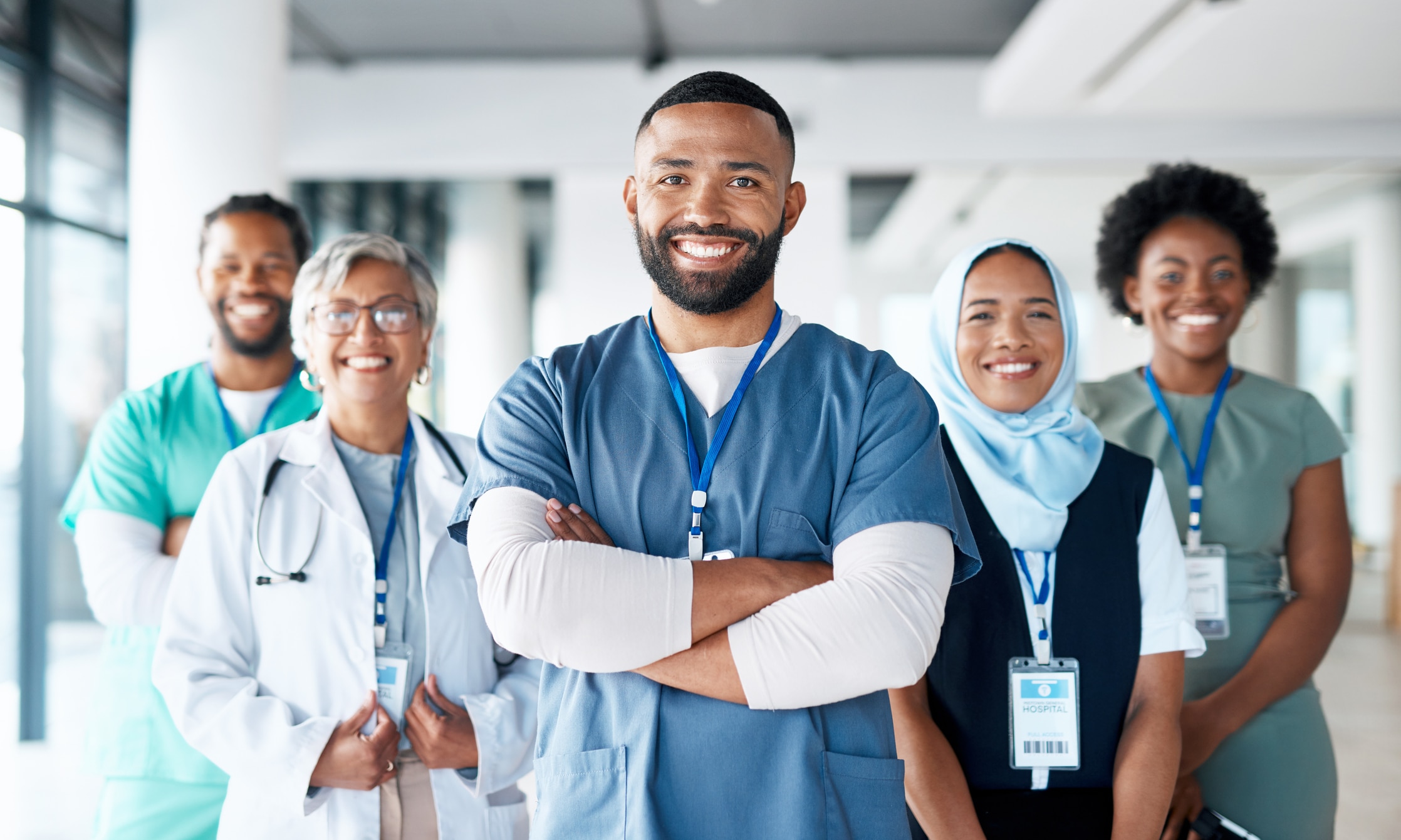 Healthcare professionals standing looking at the camera smiling