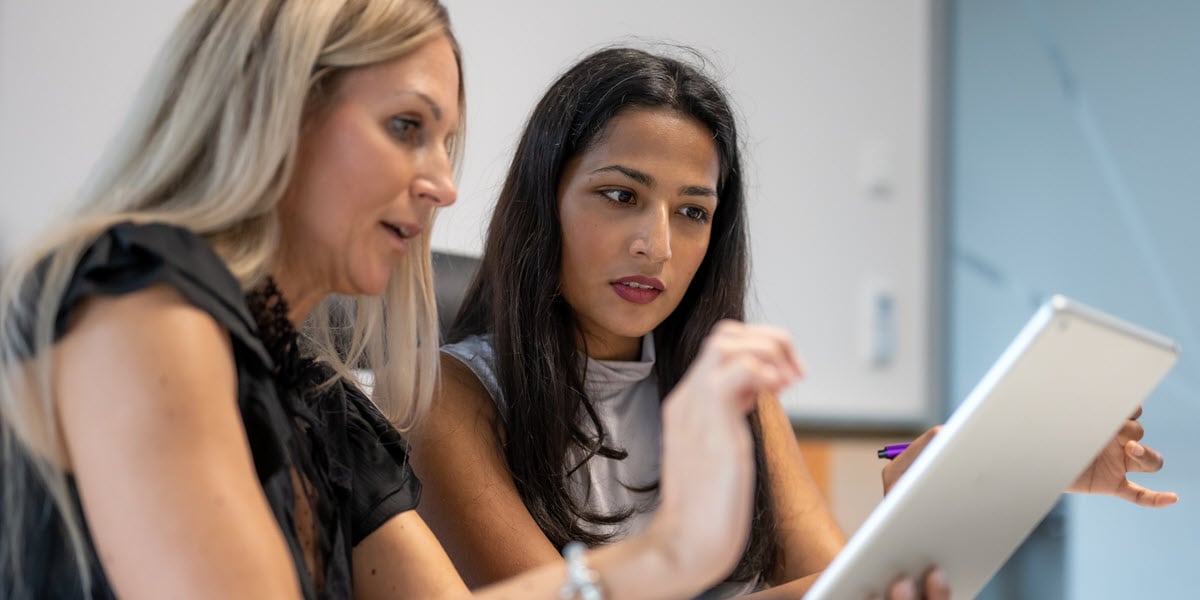 Two women looking at tablet