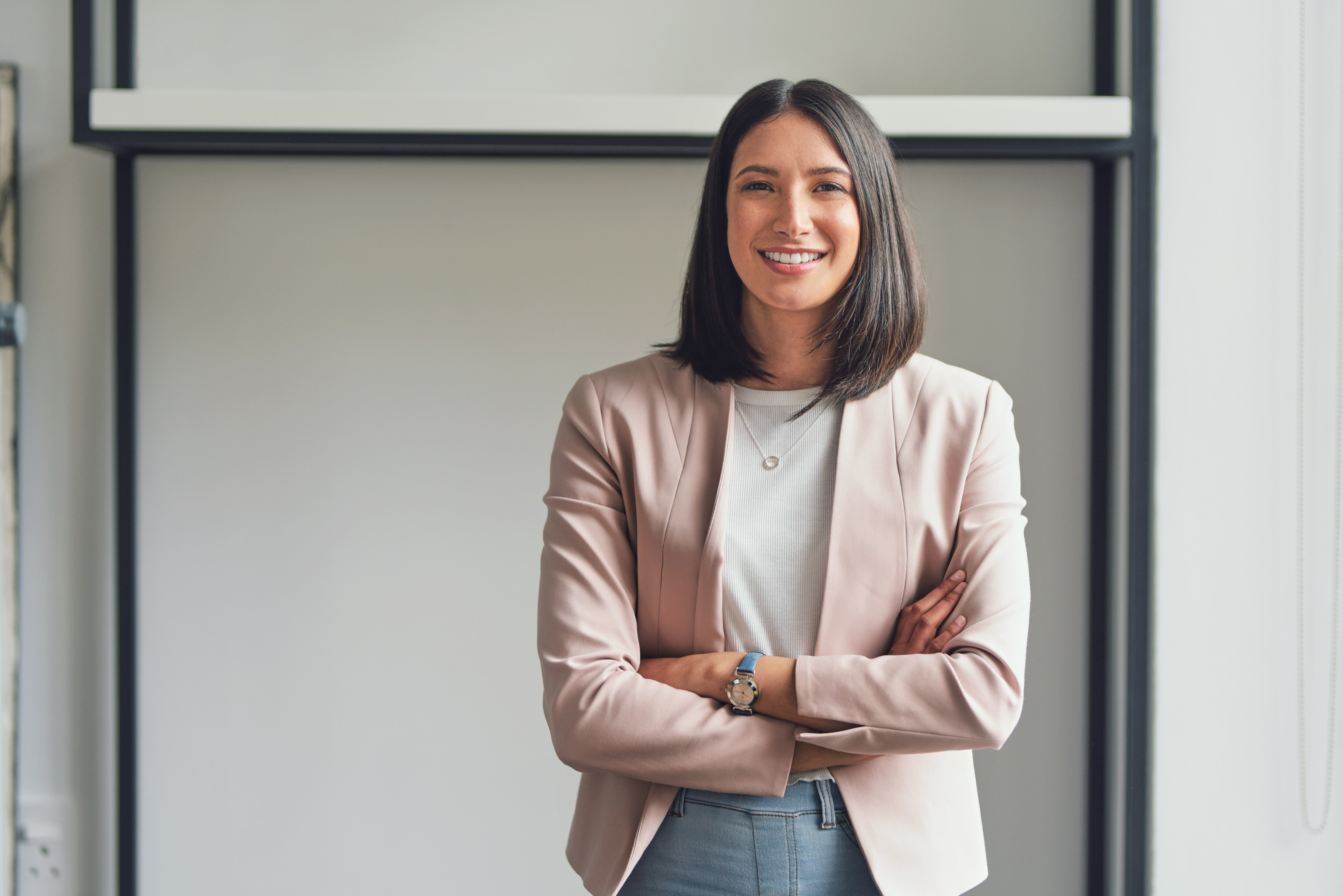 Woman with arms crossed smiling at camera