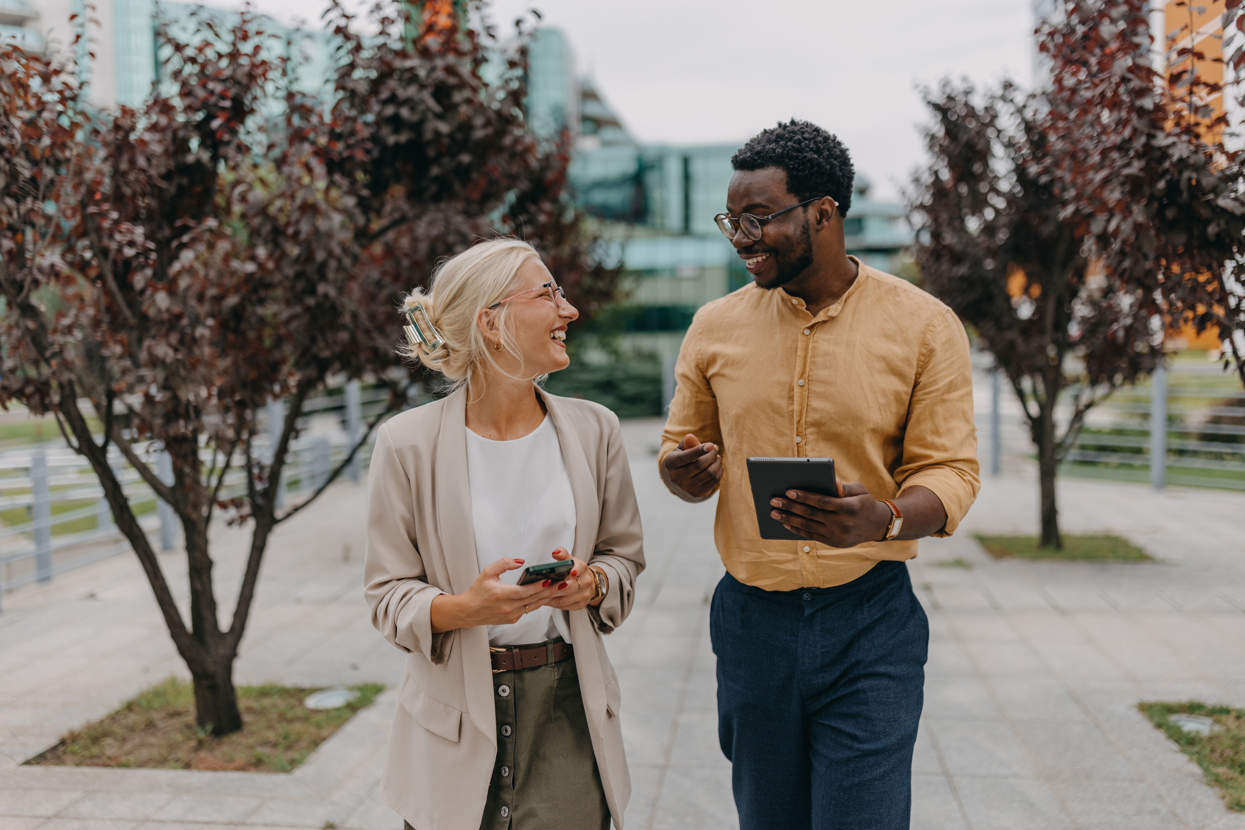 Woman and man walking together smiling at each other