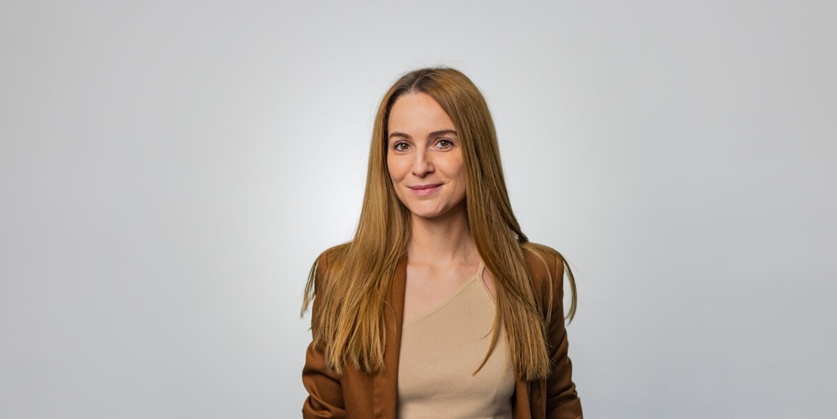 woman in brown blazer 