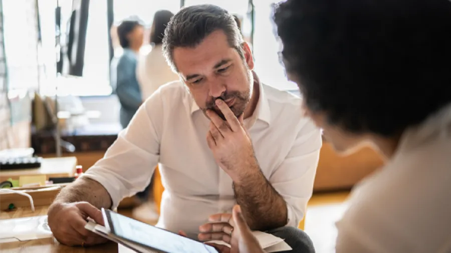 Man looking at screen with woman