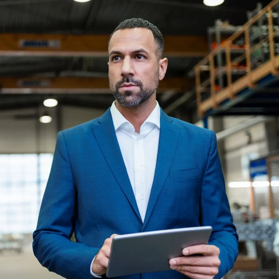 man holding tablet in manufacturing warehouse