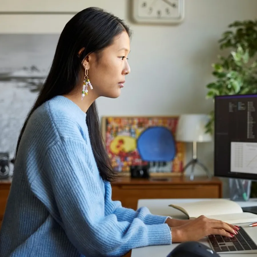 woman working on dual screens