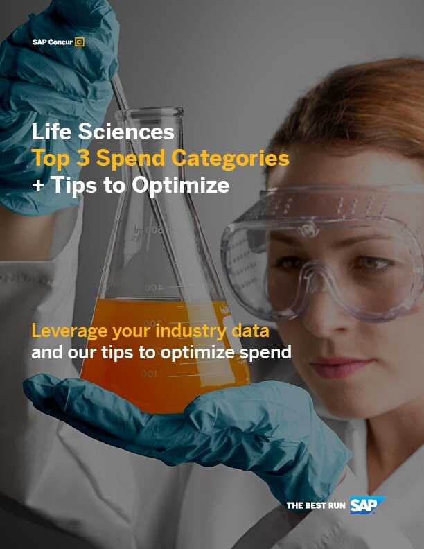A scientist peers closely into a beaker filled with orange fluid